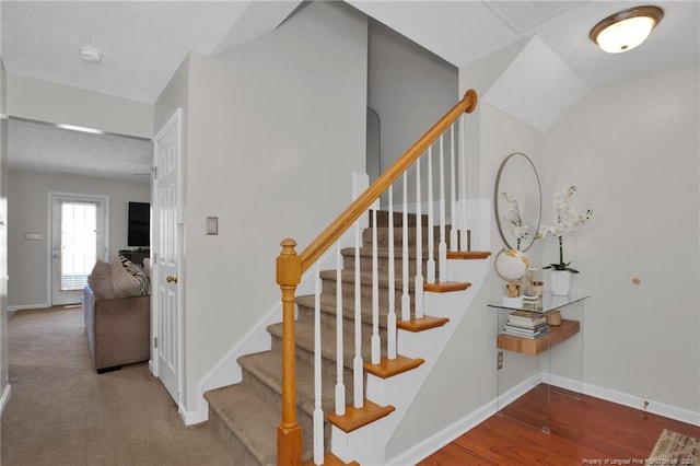 stairway with baseboards and wood finished floors