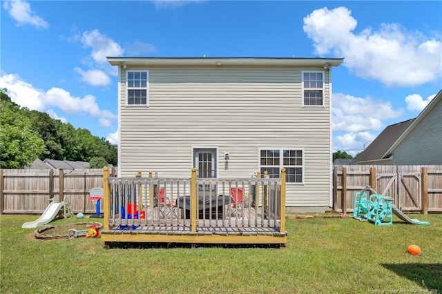 rear view of house featuring a fenced backyard, a lawn, and a deck