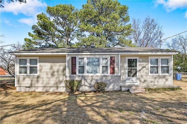 view of front of property with entry steps, crawl space, brick siding, and a front yard