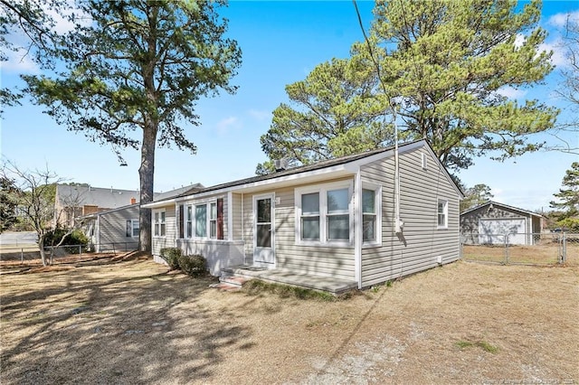 view of front of home with fence and a front lawn