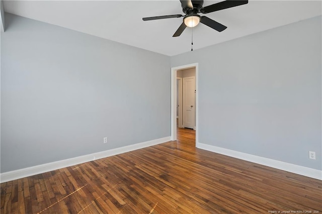 unfurnished room with a ceiling fan, baseboards, and wood finished floors