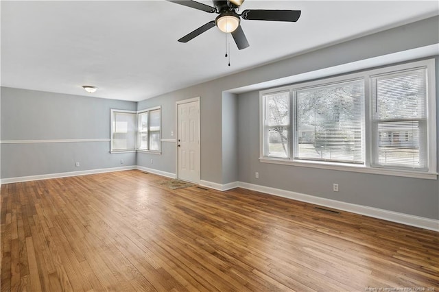 unfurnished living room with baseboards, visible vents, and light wood-style floors