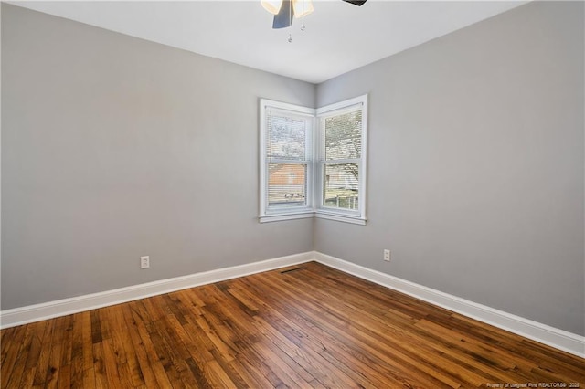 unfurnished room with ceiling fan, baseboards, and hardwood / wood-style flooring