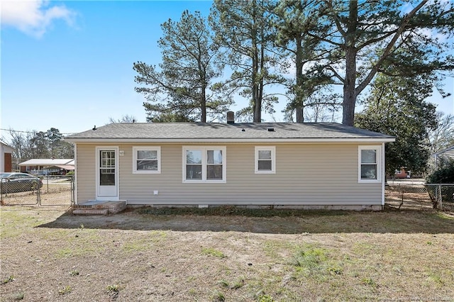 back of house featuring fence and a lawn