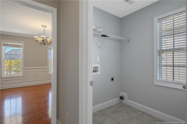 washroom with laundry area, wood finished floors, hookup for a washing machine, a chandelier, and electric dryer hookup