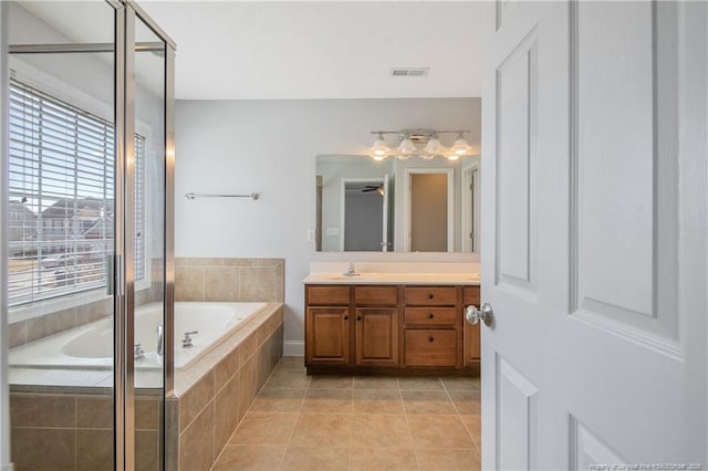 bathroom featuring visible vents, vanity, a shower stall, a bath, and tile patterned floors