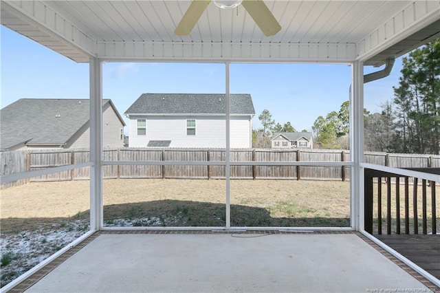 unfurnished sunroom with a ceiling fan