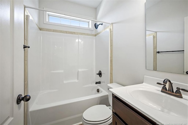 bathroom with toilet,  shower combination, and vanity