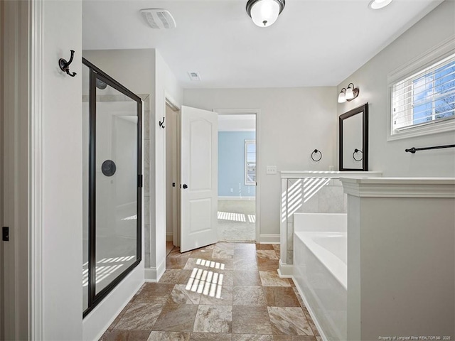 full bathroom with visible vents, baseboards, a bath, stone finish floor, and a stall shower