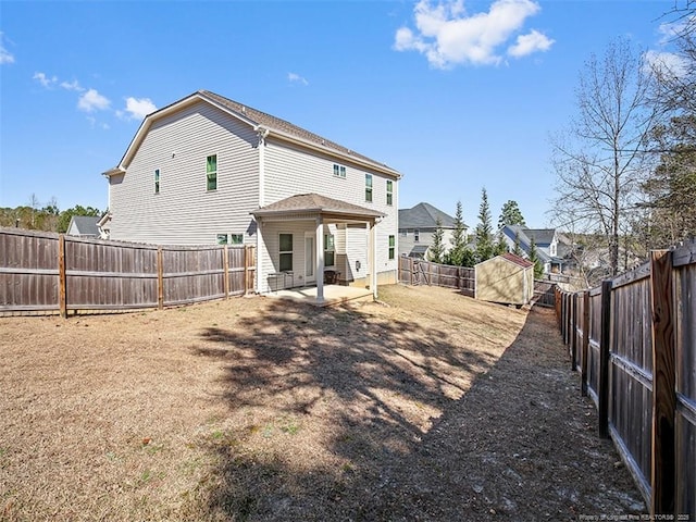 rear view of house featuring a fenced backyard