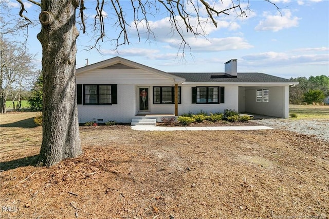 ranch-style home with crawl space, brick siding, and a chimney