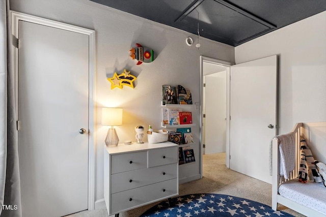 bedroom featuring carpet floors and attic access