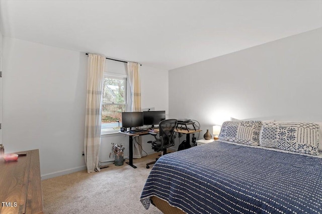 carpeted bedroom featuring baseboards