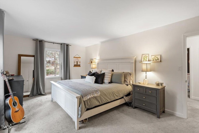 bedroom featuring light carpet and baseboards