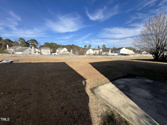 view of yard featuring a residential view and fence