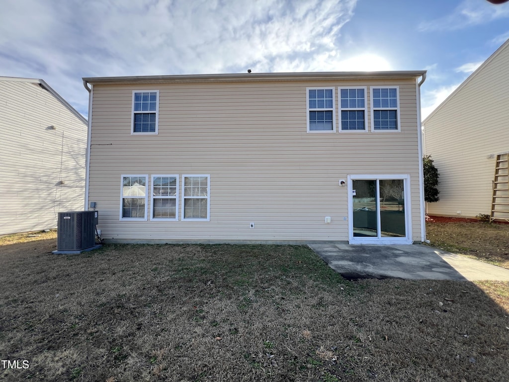 back of house with a lawn, a patio, and central AC unit