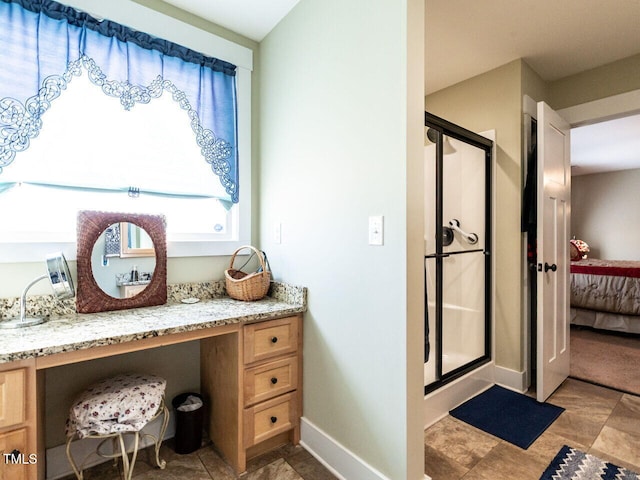 full bathroom with a stall shower, ensuite bath, baseboards, and vanity