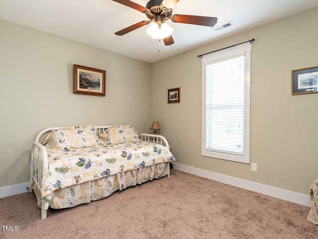 carpeted bedroom with ceiling fan, visible vents, and baseboards