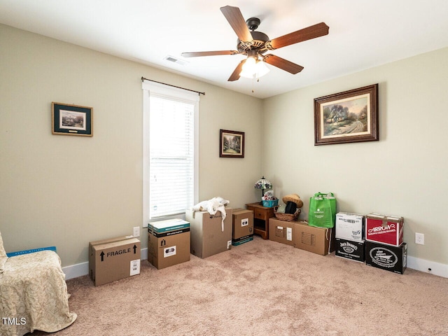 interior space featuring a ceiling fan, carpet, visible vents, and baseboards