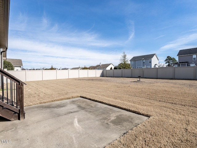 view of yard with a patio and a fenced backyard