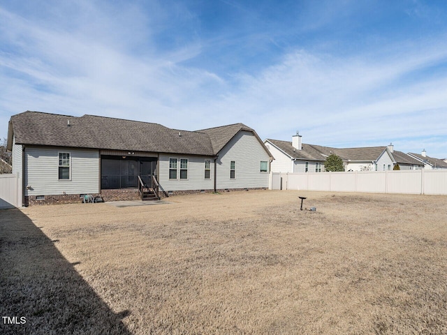 rear view of property featuring crawl space, a fenced backyard, and roof with shingles