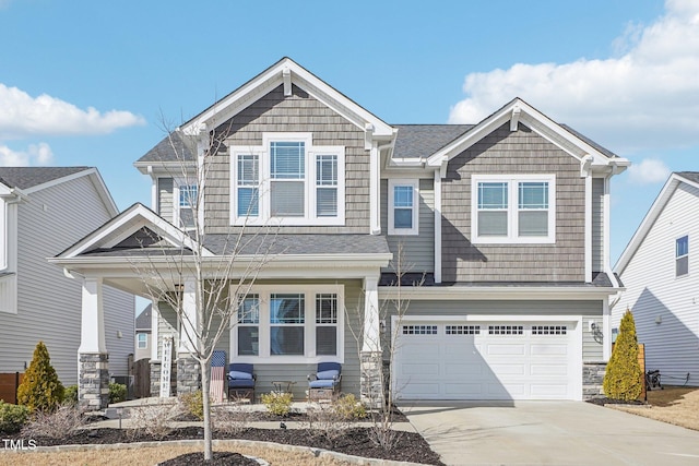 craftsman house featuring a garage, driveway, and a porch