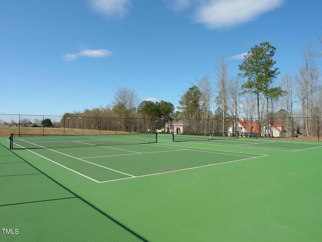 view of sport court featuring fence