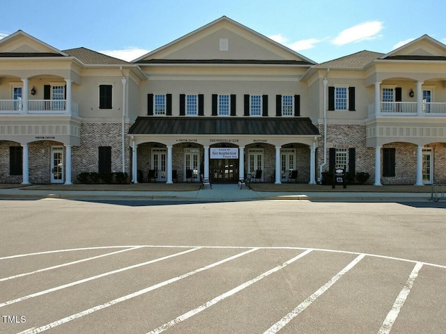 view of building exterior featuring uncovered parking