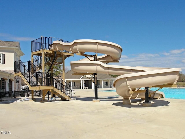 exterior space with stairs and a community pool