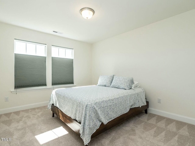 bedroom featuring carpet flooring, visible vents, and baseboards