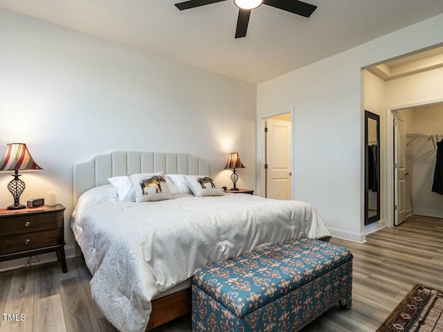 bedroom featuring ceiling fan, wood finished floors, and baseboards