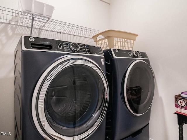 washroom featuring laundry area and washer and dryer