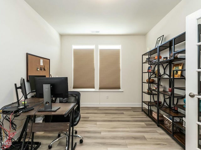 home office with wood finished floors and baseboards