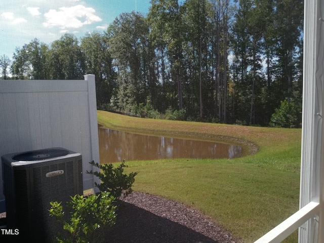 view of yard with a water view and central AC unit