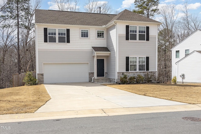 view of front facade with driveway, stone siding, a shingled roof, and a front lawn