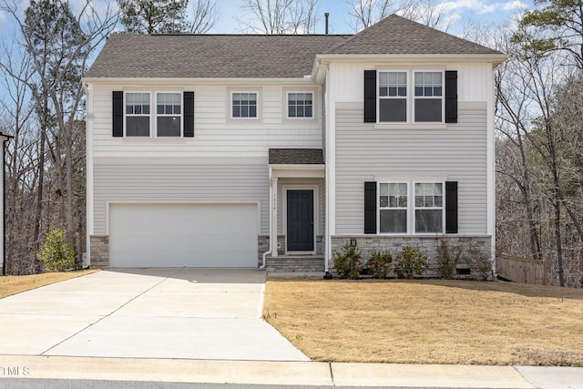 view of front facade with roof with shingles, concrete driveway, a front yard, a garage, and stone siding