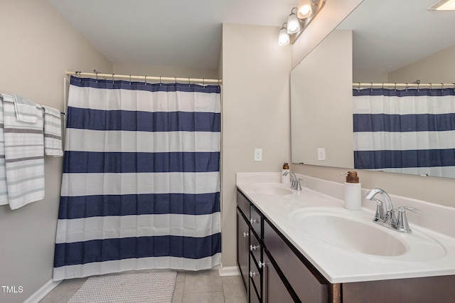 full bathroom with a shower with curtain, double vanity, a sink, and tile patterned floors