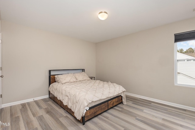 bedroom featuring wood finished floors and baseboards