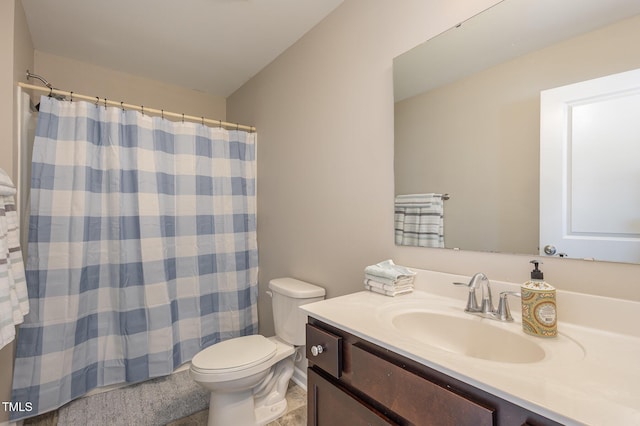 bathroom featuring curtained shower, vanity, and toilet