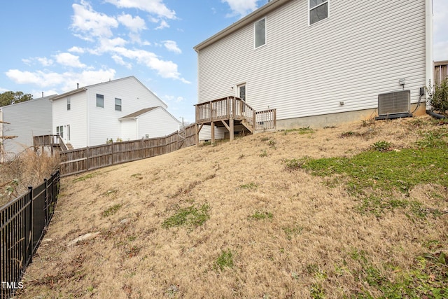 exterior space with central air condition unit and fence