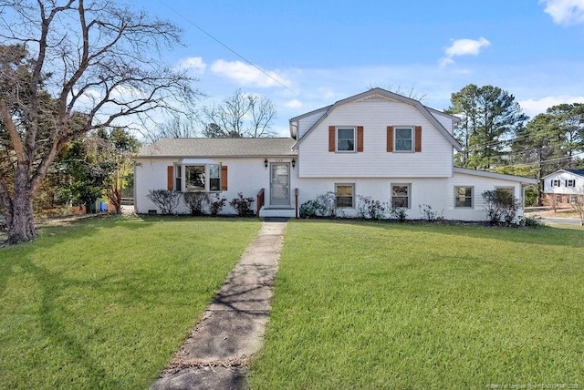 tri-level home with a front yard and a gambrel roof