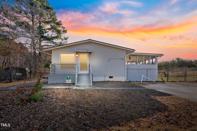 view of front of property featuring crawl space and fence