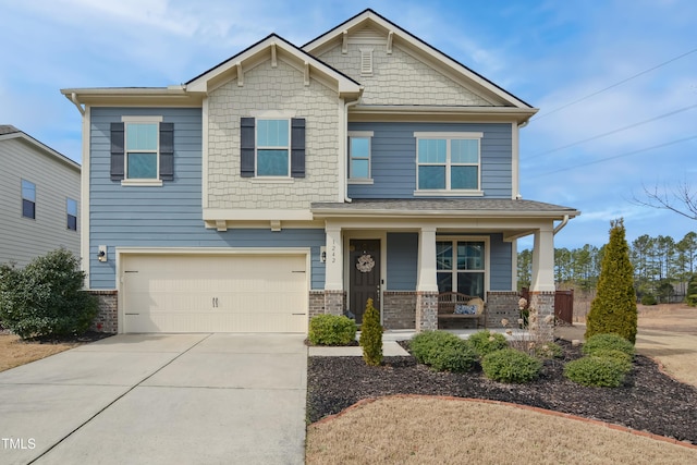 craftsman-style house featuring a garage, covered porch, concrete driveway, and brick siding