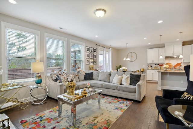 living room with plenty of natural light, visible vents, wood finished floors, and recessed lighting