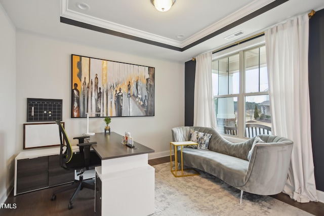 office area with a tray ceiling, wood finished floors, visible vents, and crown molding