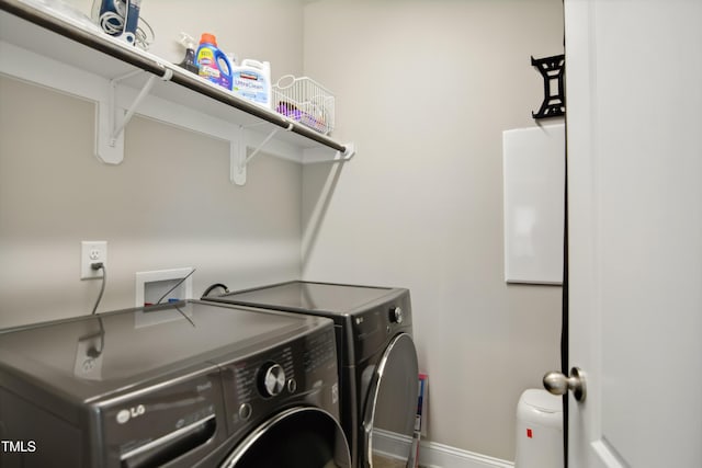 laundry room with laundry area, washer and clothes dryer, and baseboards