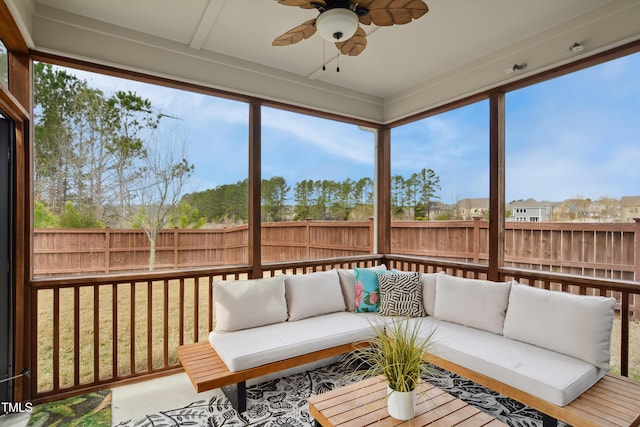 sunroom / solarium featuring a ceiling fan