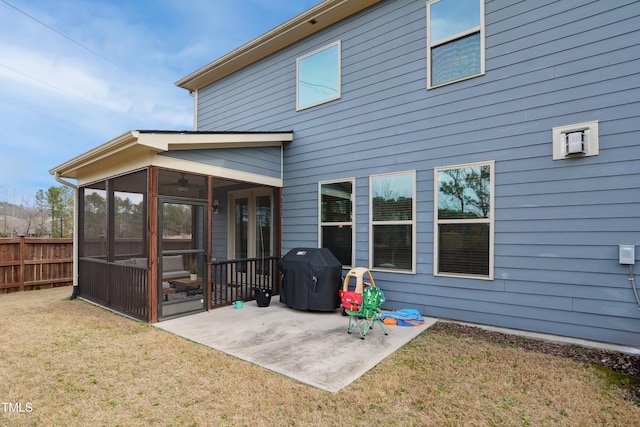 back of house featuring a patio area, fence, a sunroom, and a yard