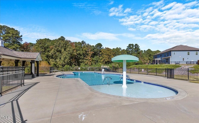 community pool featuring a patio area and fence