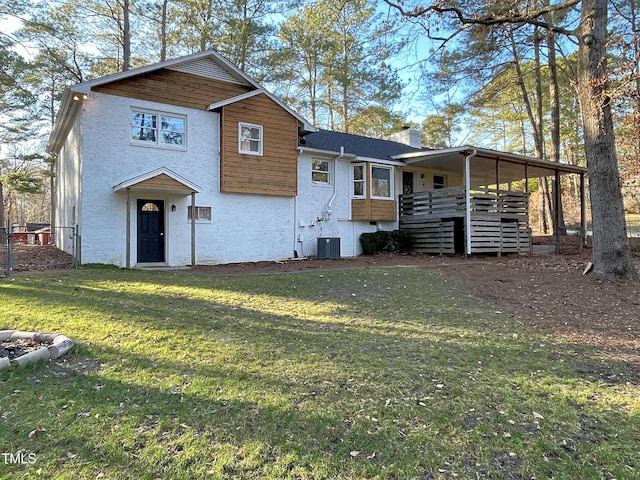 view of front of house featuring a chimney, central AC unit, and a front lawn